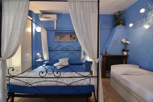 a blue bedroom with a bed with blue walls at Villa Isabella in Marina di Grosseto