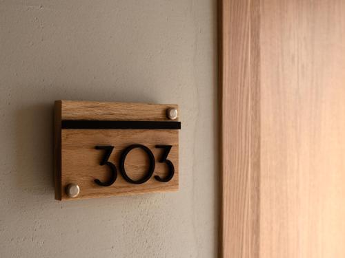 a woodenswitch on a wall next to a door at Apollo Plakias in Plakias