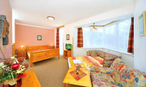 a living room with a couch and a table at Pension Villa Stella in Špindlerův Mlýn