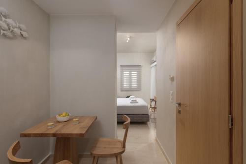 a room with a wooden table and a bedroom at Apollo Plakias in Plakias