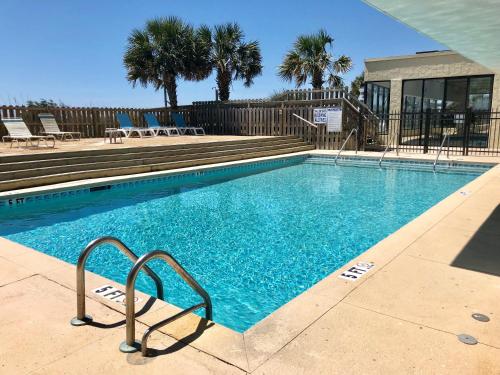 a swimming pool with blue water in a resort at Water Pointe I 503 Condo in Myrtle Beach