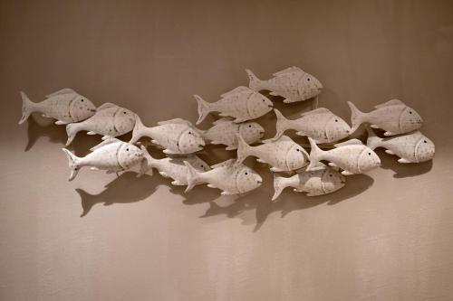 a group of white fish on the wall at Apollo Plakias in Plakias