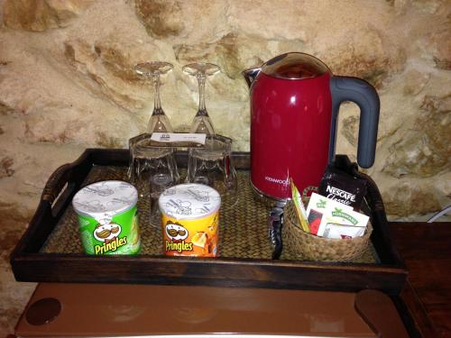 a tray with a tea kettle and drinks and glasses at Agroturismo Xarc in Santa Eularia des Riu