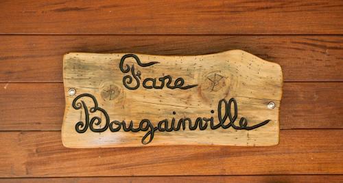 a sign on a wooden door with the words save development at Robinson's Cove Villas in Papetoai