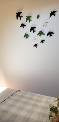 a group of birds flying in the sky at Trajadinha - Casa da Travessa in Caminha