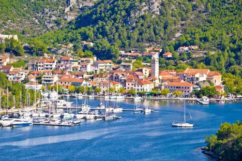 a group of boats docked in a harbor at Apartmani Marijana in Lozovac