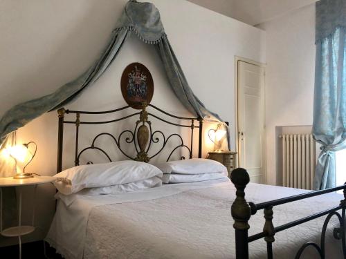 a bedroom with a large bed with a canopy at Masseria Rienzo in Ostuni