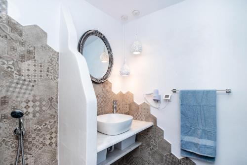 a bathroom with a sink and a mirror at Koskinou Traditional Houses in Koskinou
