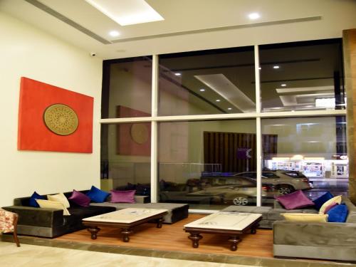 a living room with a couch and two coffee tables at Clarks Inn Suites Katra in Katra
