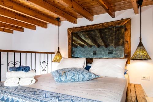 a bedroom with a bed with towels on it at Koskinou Traditional Houses in Koskinou