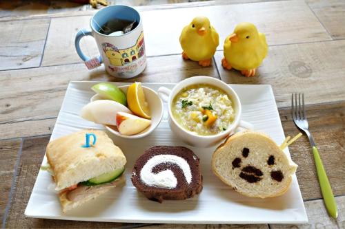 a plate of food with a sandwich and a cup of coffee at 依比鴨鴨水岸會館 Ducking House in Ruisui