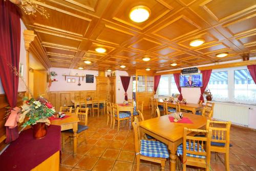 a dining room with wooden tables and chairs at Pension Villa Stella in Špindlerův Mlýn