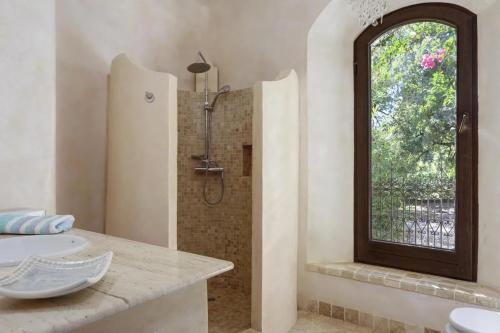 a bathroom with a shower and a sink and a window at Villa Bella Vista in Gaucín
