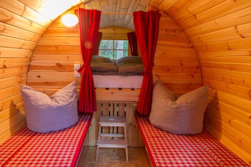 a room with two beds in a log cabin at Waldkiez Tiefensee in Tiefensee