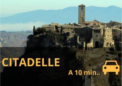a poster of a castle with a car on a hill at Duplex Vauban - Home-one in Dannemarie-sur-Crête