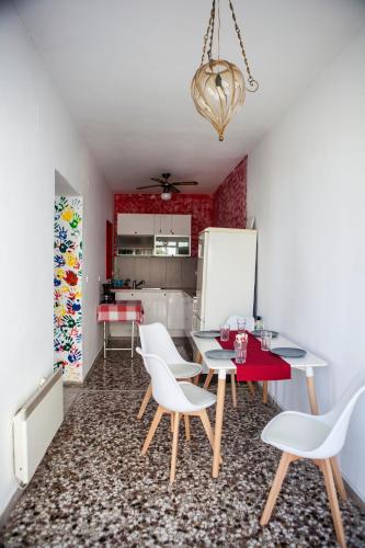a dining room with a table and chairs and a refrigerator at Family House in Lakones in Paleokastritsa