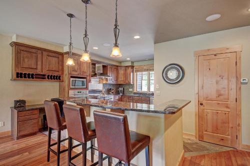 a kitchen with a large island with bar chairs at 39C Union Creek Townhomes West Townhouse in Copper Mountain