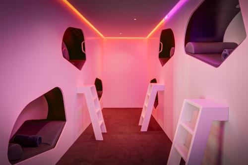 a room with pink and black chairs and lights at Fletcher Wellness-Hotel Sittard in Sittard