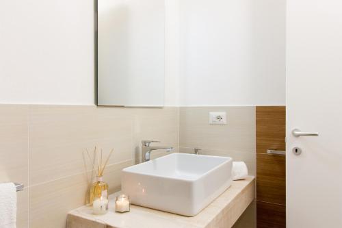 a bathroom with a white sink on a counter at Appartamenti Shardana in Villasimius