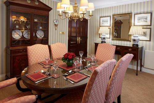 a dining room with a wooden table and chairs at Cheval Thorney Court at Hyde Park in London