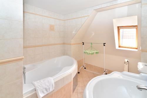 a bathroom with a tub and a sink at Historic Centre Apartments VIII in Prague