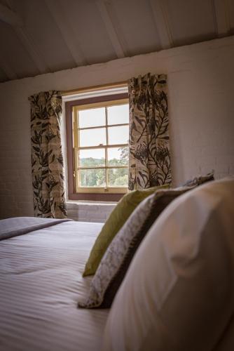 a bed in a room with a window at The Barracks, Tocal in Paterson