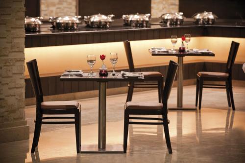 two tables with wine glasses on them in a restaurant at Move On Beach Resort Al Khobar in Half Moon Bay