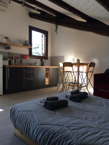 a bedroom with a bed and a kitchen with a table at La mansardina in Padova