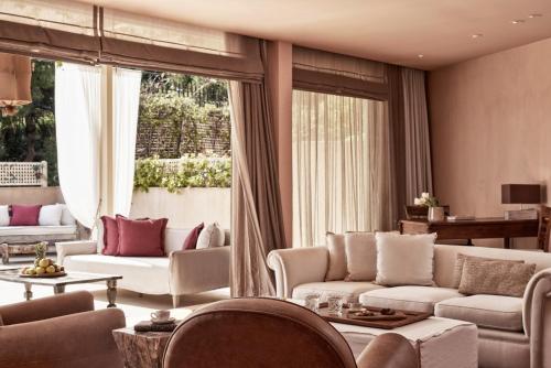 a living room with white couches and a large window at The Margi in Athens
