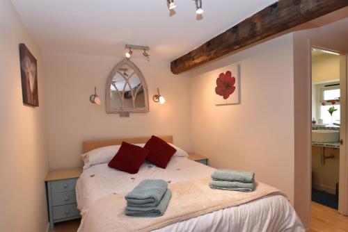 a bedroom with a bed and a mirror at Studio 22 in Rye