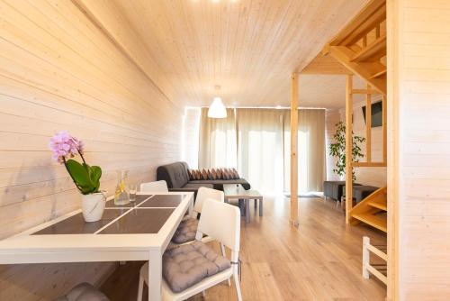 a living room with a table and a couch at Old Tree Village & Restaurant in Oświęcim