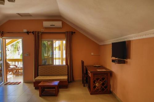 a living room with a couch and a television and a table at LAGUNA BEACH in Morondava
