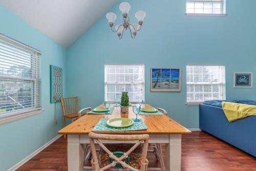 a dining room with a table and a couch at Seawalk Cottage in Tybee Island