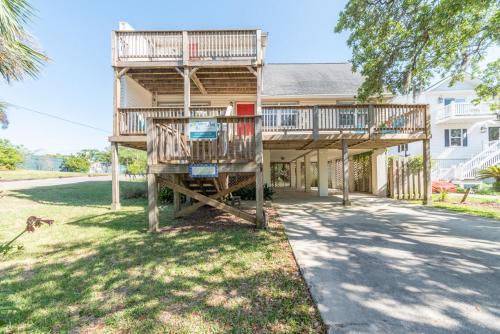 a house with two balconies on the front of it at Seawalk Cottage in Tybee Island