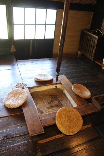 a group of straw seats on the floor of a room at Guesthouse boro-ya in Otoyocho
