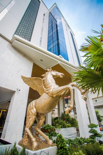 a gold horse statue in front of a building at SN Connx - SHA Plus in Pattaya Central