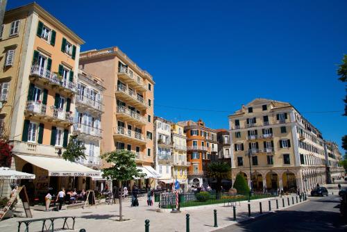 a street in a city with buildings and people at Old Fortress Luxury Suite in Corfu Town