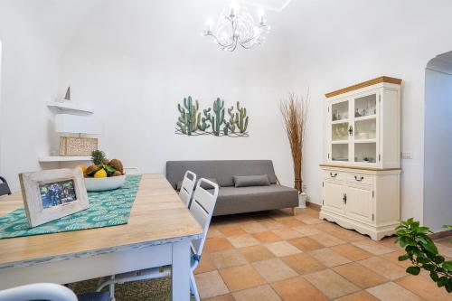 a living room with a table and a couch at Nonna Carmela Apartment in SantʼAgata sui Due Golfi
