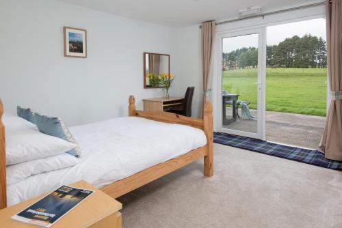 a bedroom with a bed and a sliding glass door at Brown Rigg Lodges in Bellingham