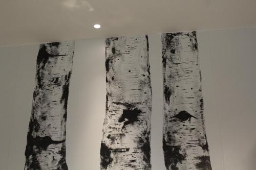 two birch trees on a wall in a room at Serre Alte Landscape Luxury Rooms in Matelica