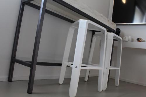 a white and black table and chair in a kitchen at Serre Alte Landscape Luxury Rooms in Matelica