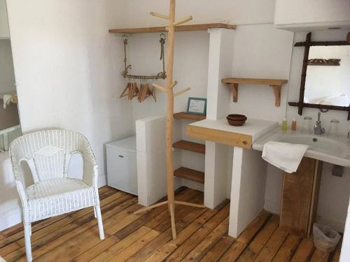 a bathroom with a desk and a chair and a sink at Hôtel Lido Beach in Hyères