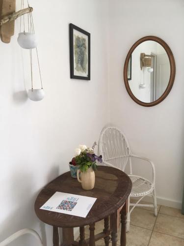 a table and chairs in a room with a mirror at Hôtel Lido Beach in Hyères
