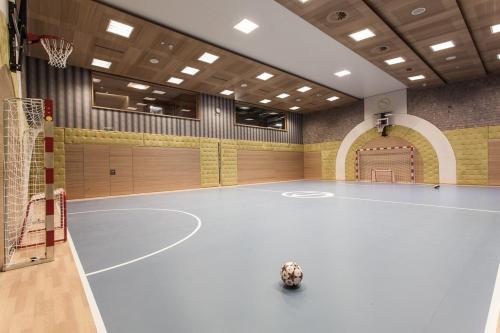 an indoor basketball court with a ball on the court at Stock Resort in Finkenberg