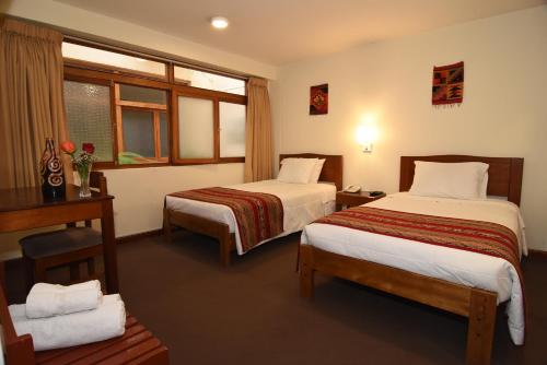 Postel nebo postele na pokoji v ubytování Hotel Prisma Cusco