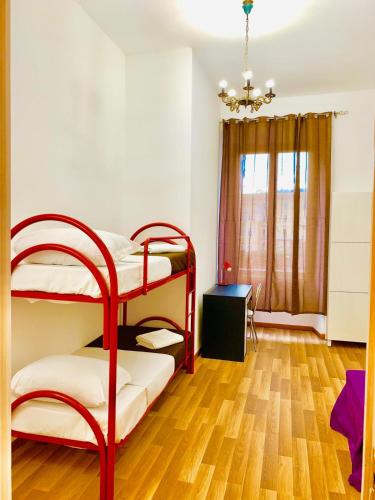 a bedroom with two bunk beds and a wooden floor at COMFORT INN ROMA TERMINI in Rome