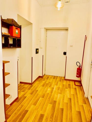 an empty room with a white door and a wooden floor at COMFORT INN ROMA TERMINI in Rome