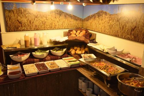 a buffet with many different types of food on display at Hotel Prisma Cusco in Cusco