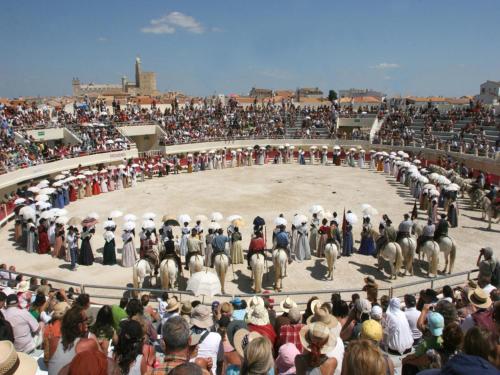 a large crowd of people standing in front of a ring at Hôtel Le Neptune en Camargue in Saintes-Maries-de-la-Mer