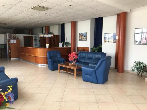 a living room filled with furniture and a blue couch at Hotel Omorika in Punat